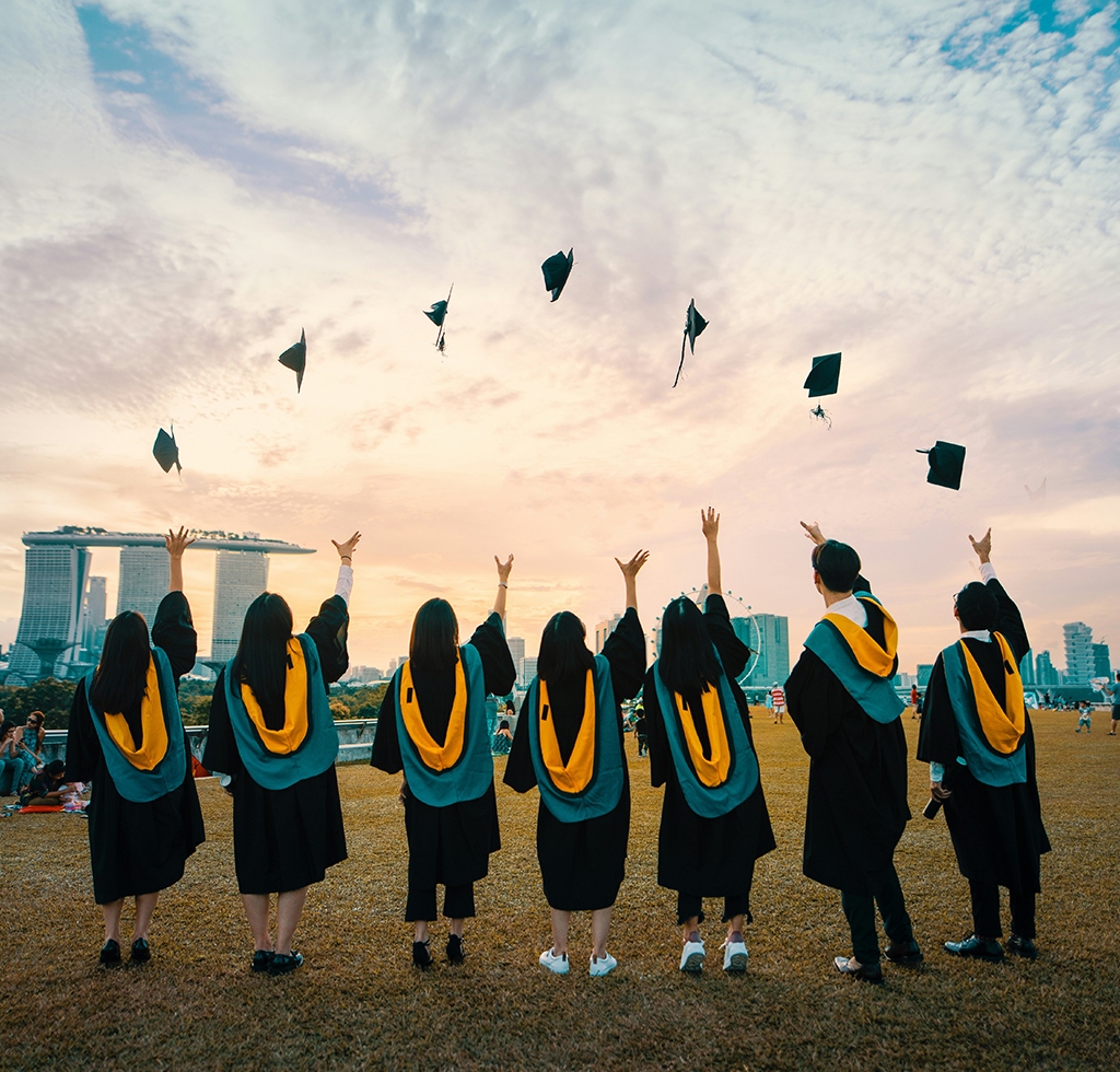 NSDTC Graduates celebrating their success by throwing caps in the air.