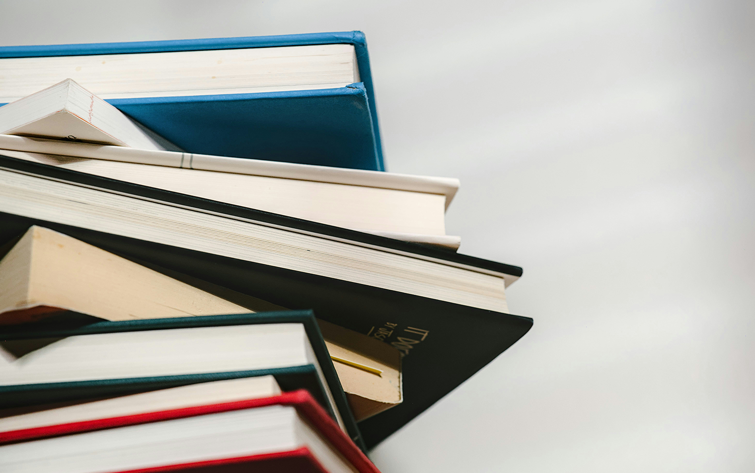 Premium stack of academic and law books representing council governance and management excellence.